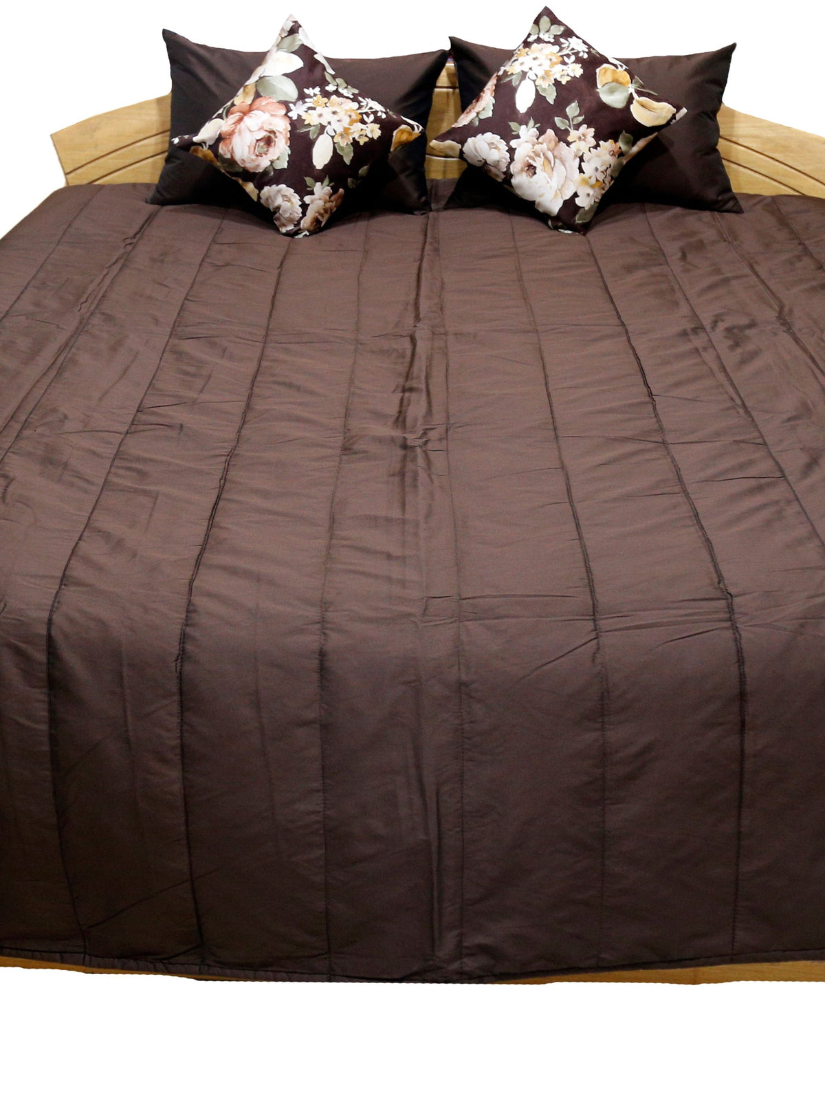 Brown pintucked bedcover flat view with two floral print cushion covers