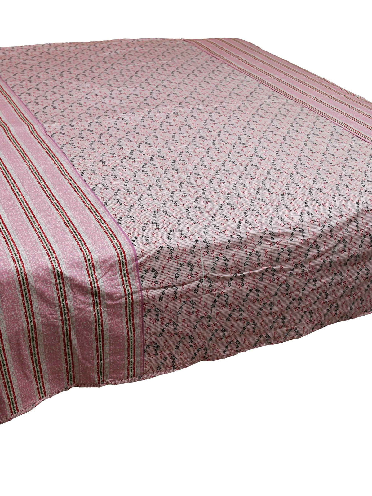 Dusty pink printed dohar on a bed, angled view showing the striped side border
