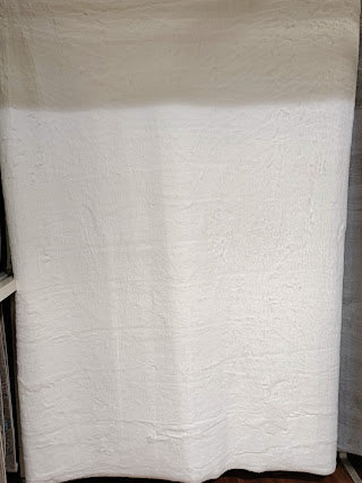 Ivory white artificial fur rug with a long, soft pile