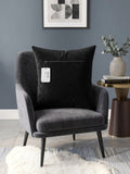 Black velvet cushion cover with geometric woven circular pattern in contrasting ivory tones