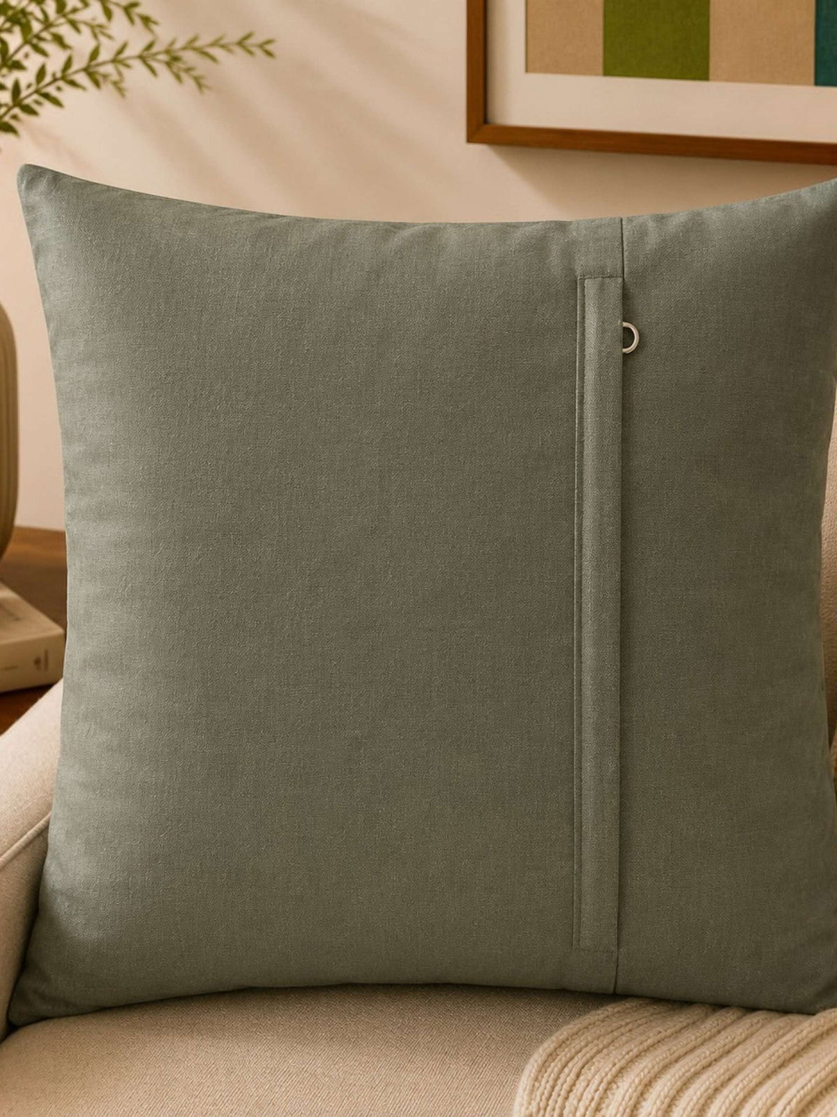 Sage green polysilk cushion cover featuring embroidered motifs with decorative bead work accents