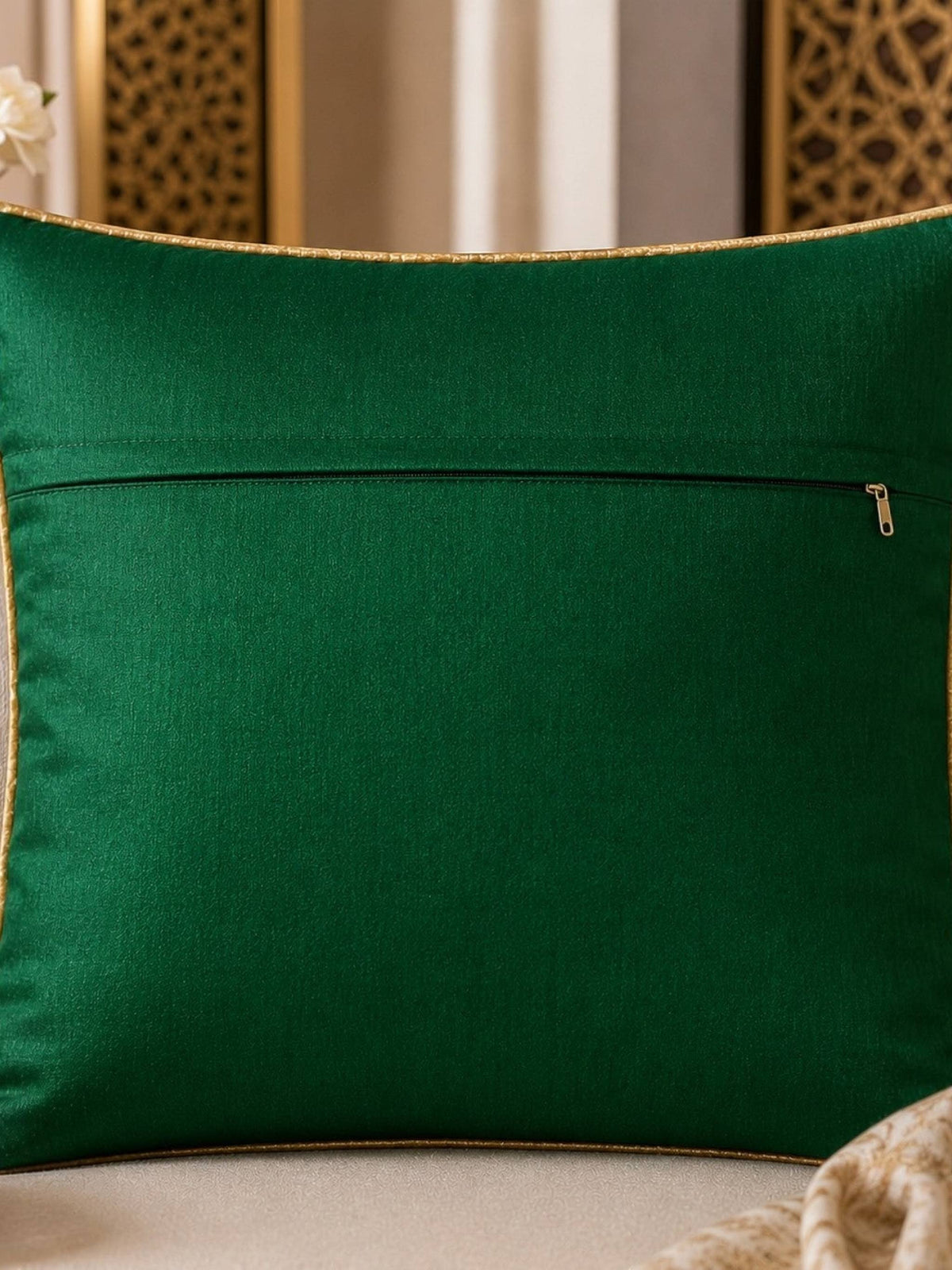 Jagdish Store emerald green throw Cushion cover with intricate shimmering gold floral embroidery and gold piping.