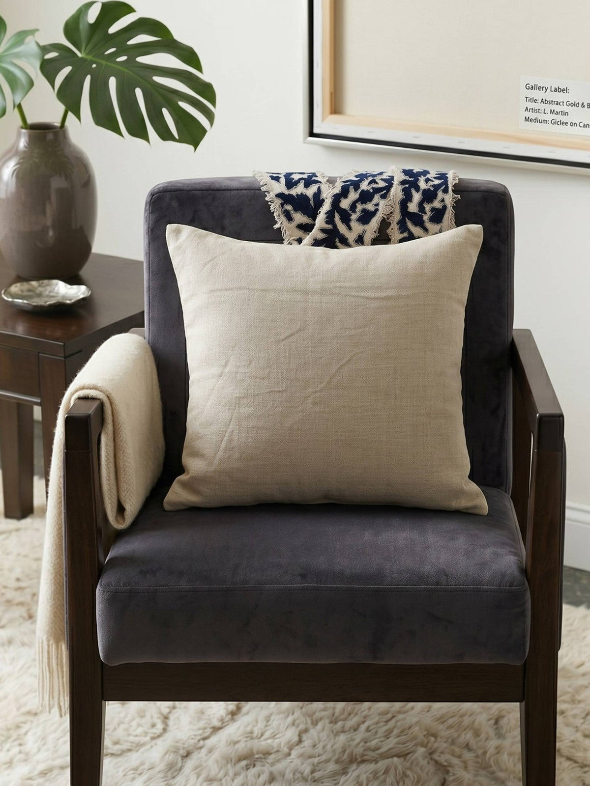 Beige cushion cover with detachable black patterned accent strip