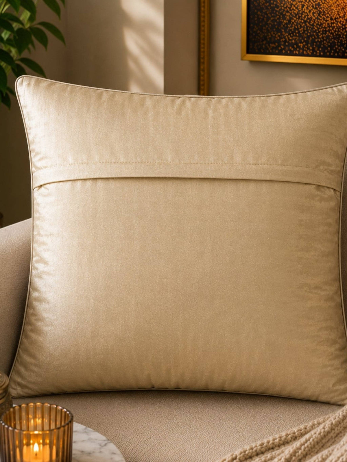 Jagdish Store decorative woven cushion cover in cream and gold with a subtle striped texture on a soft rug.