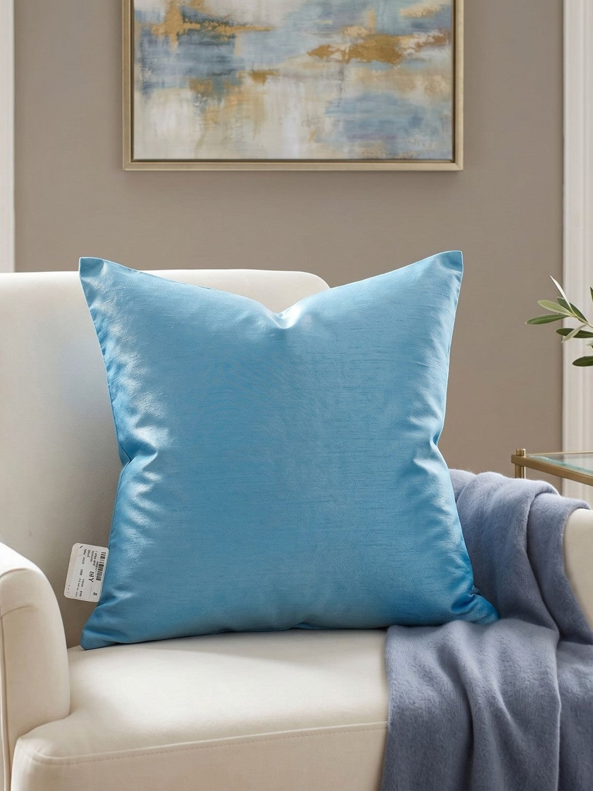 Jagdish Store embroidered decorative cushion cover in shimmering turquoise with teal, white, and gold floral embroidery and teal striped panels.