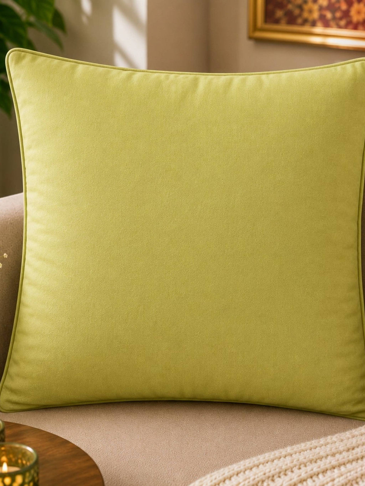 Jagdish Store lime green cushion cover with embroidered orange and gold floral pattern. Textured fabric.