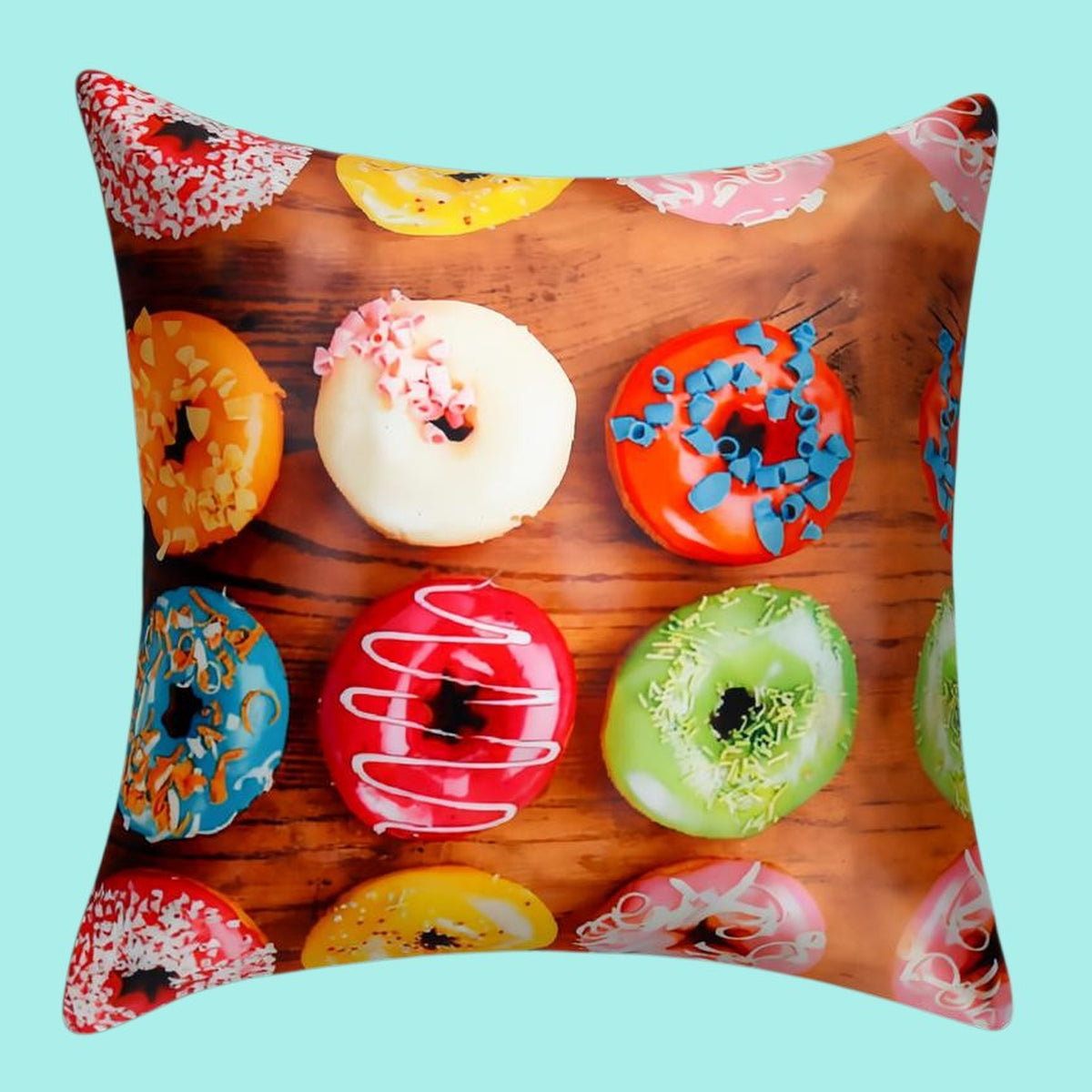 Cushion cover printed with iced doughnuts in bright colours on a wooden background