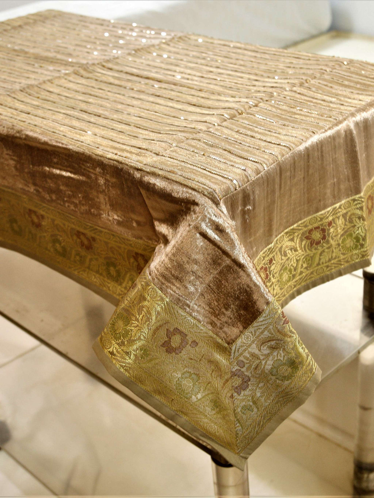 Champagne-beige velvet table cover with a sequinned stripe pattern and a gold brocade floral border