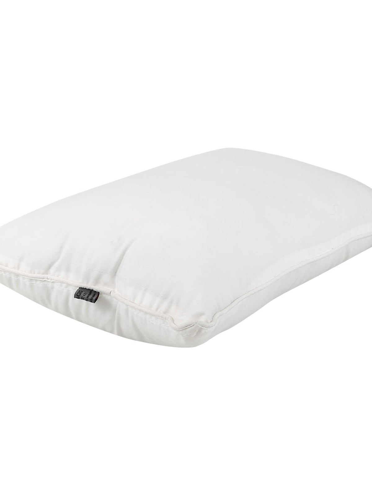 White piped polyfill pillow insert lying flat, showing the loft of the filling