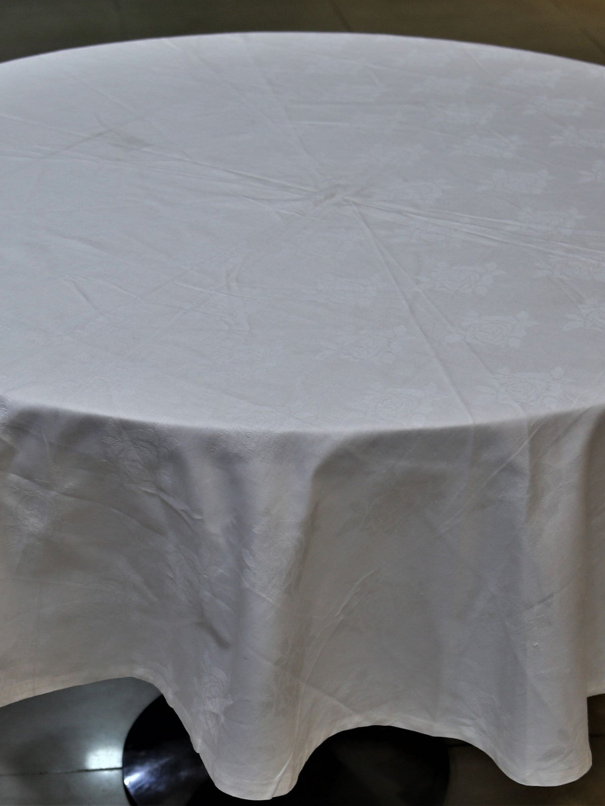 Round solid ivory cotton table cover with a self-jacquard texture