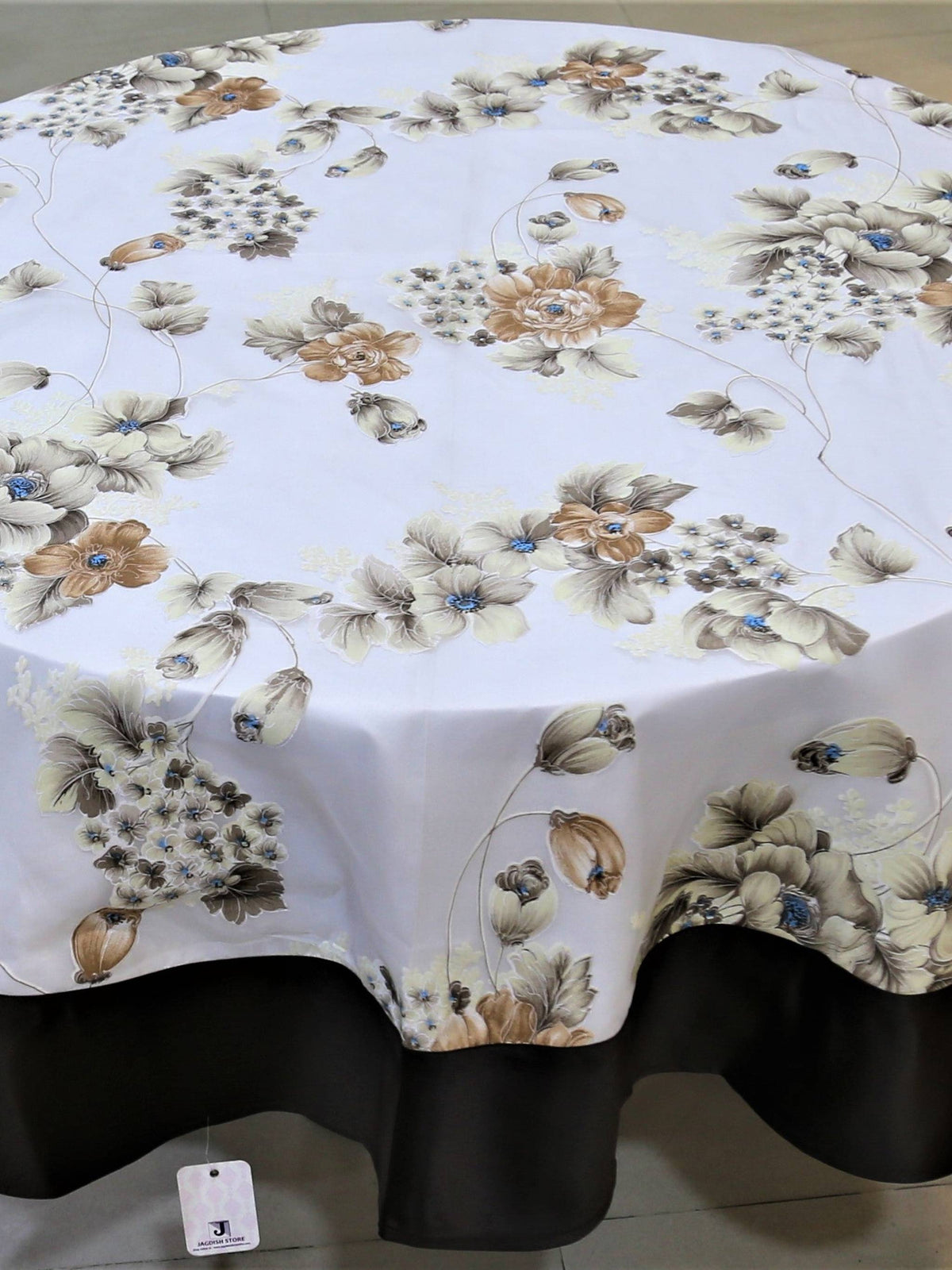 Round white table cover with a printed beige-brown floral bouquet pattern and a solid black underskirt