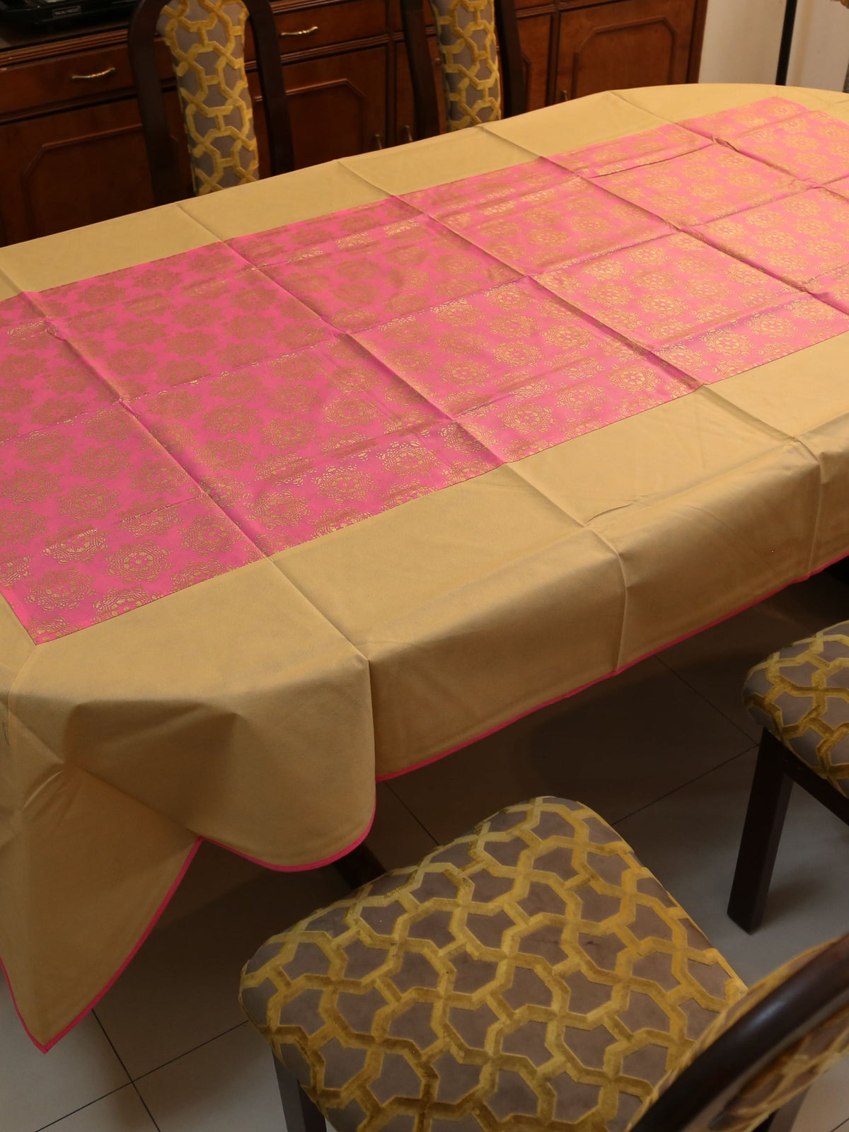 Gold-beige table cover with a contrasting pink brocade panel woven down the centre