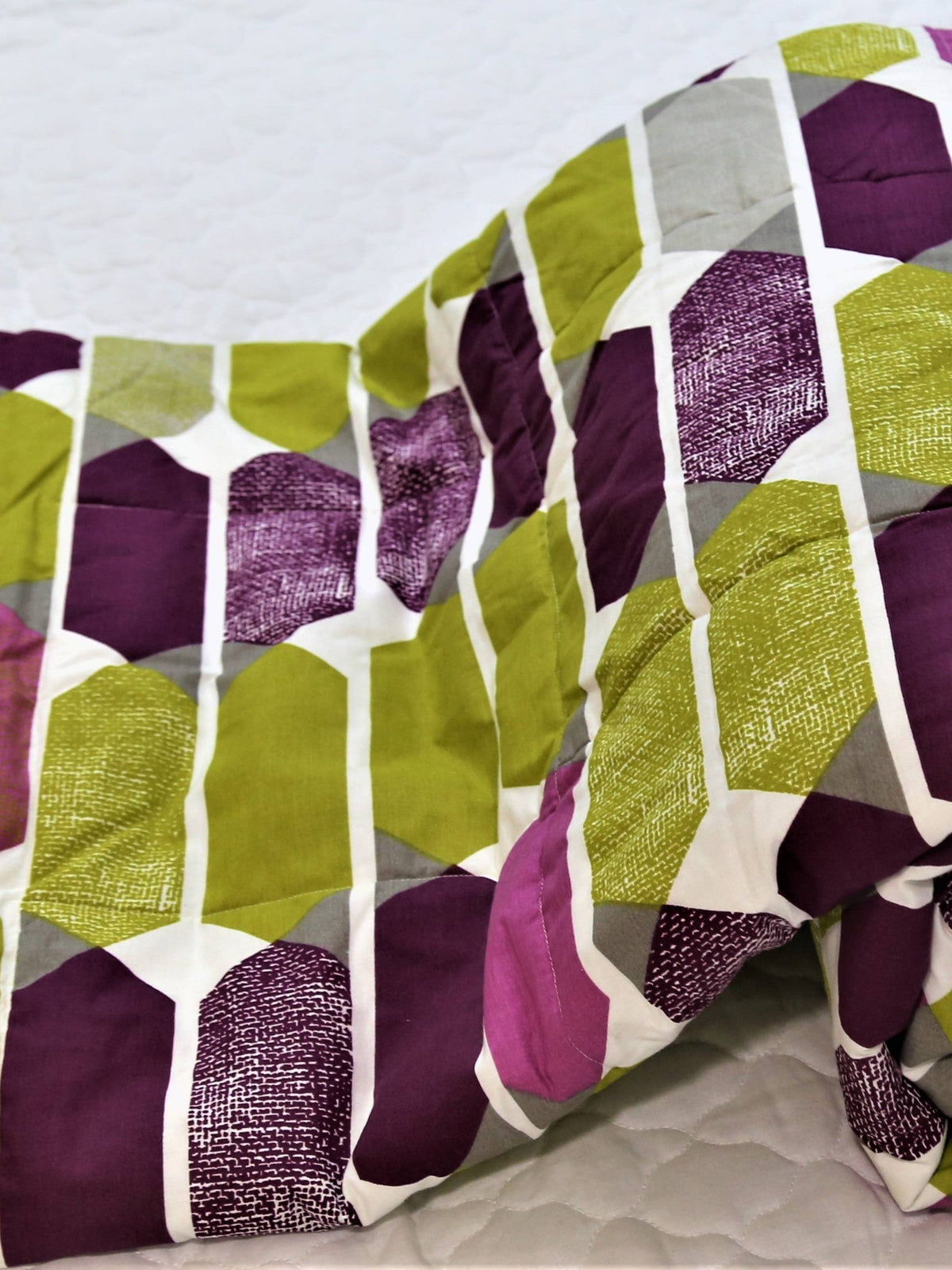 Olive-green and purple cotton single bed quilt with geometric hexagon print