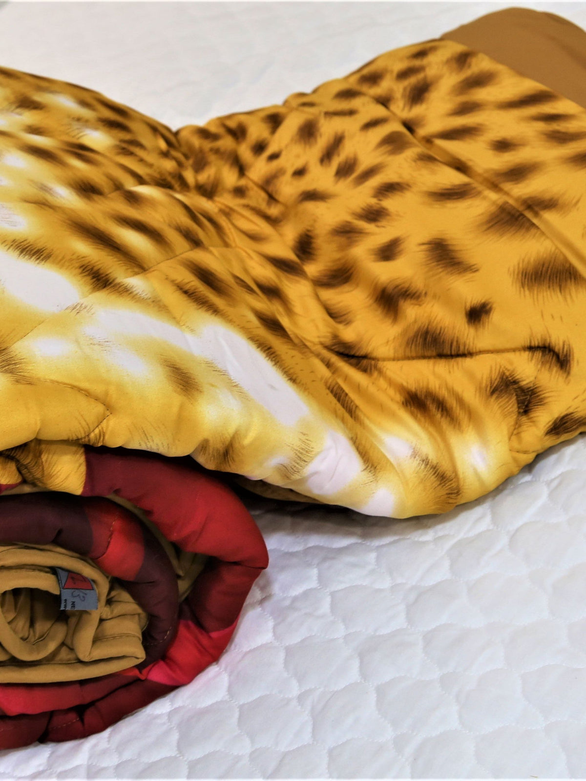 Leopard-print cotton blend AC quilt with a red rose print