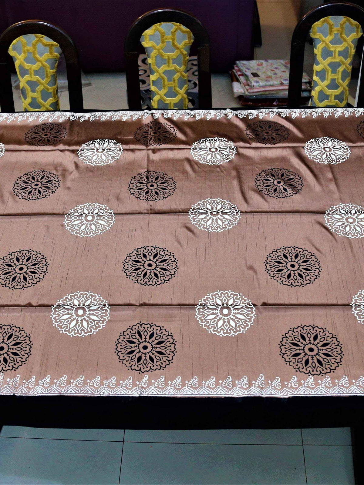 Dusty pink-brown table cover with a black and white block-printed mandala medallion pattern and a black lace-trimmed border