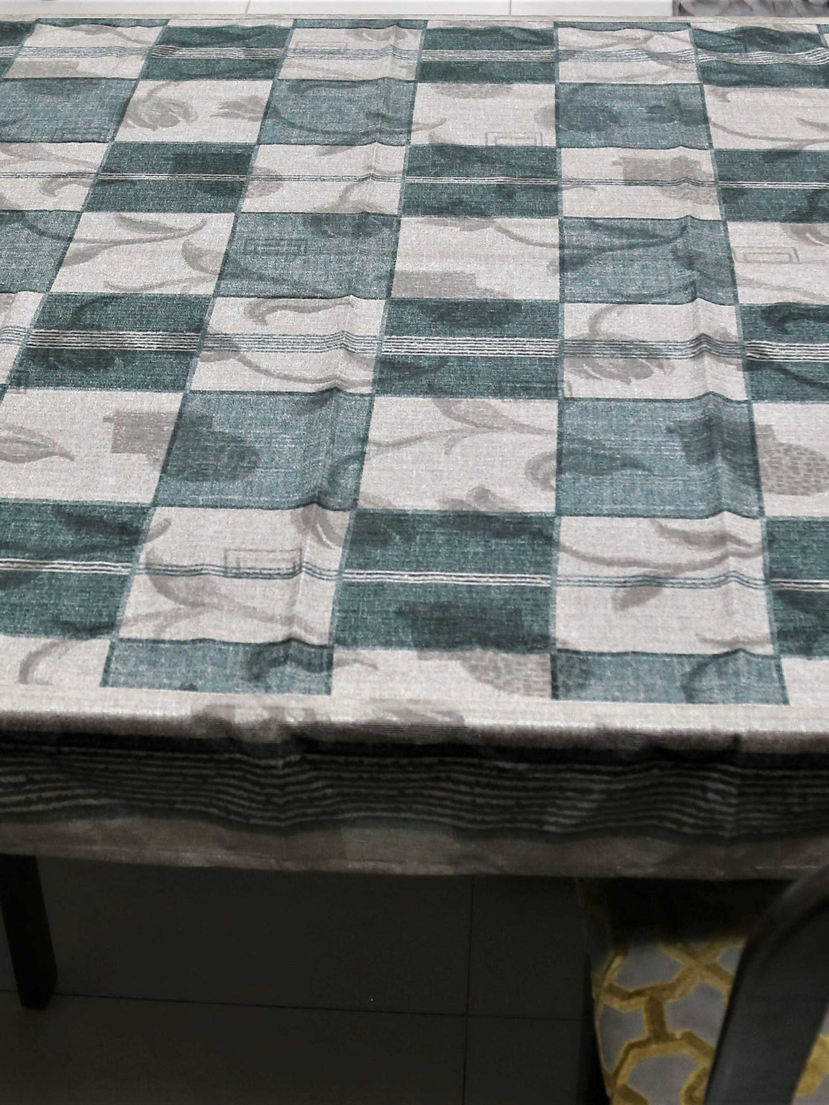 Green and cream checkered table cover with a self-tone floral jacquard pattern and a sheer green underskirt