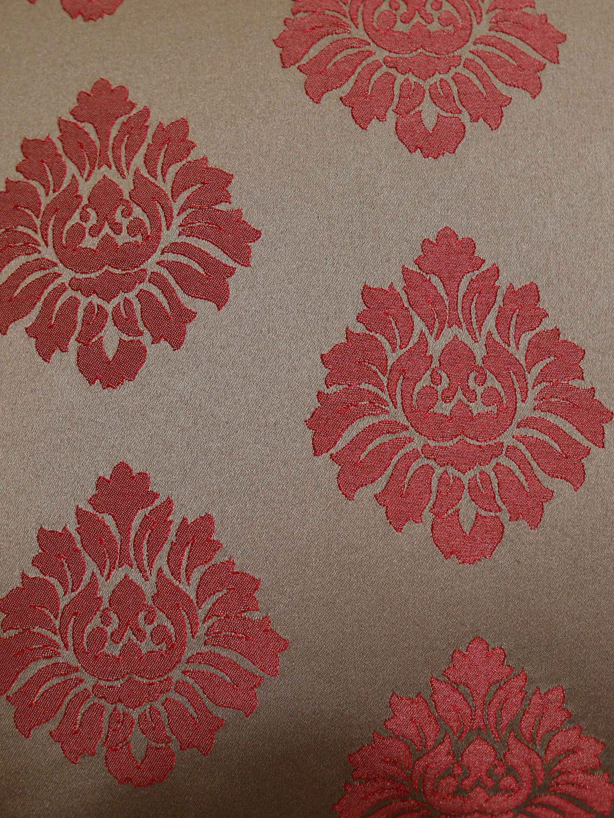 Close-up of the rust damask medallion woven on taupe