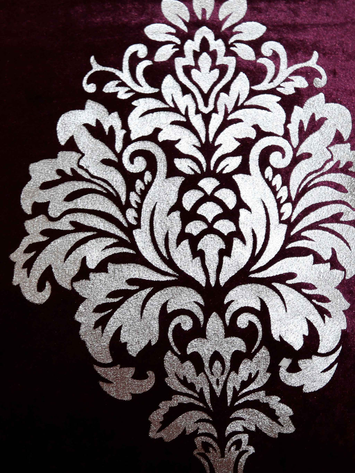 Close-up of the silver foil printed damask on wine velvet