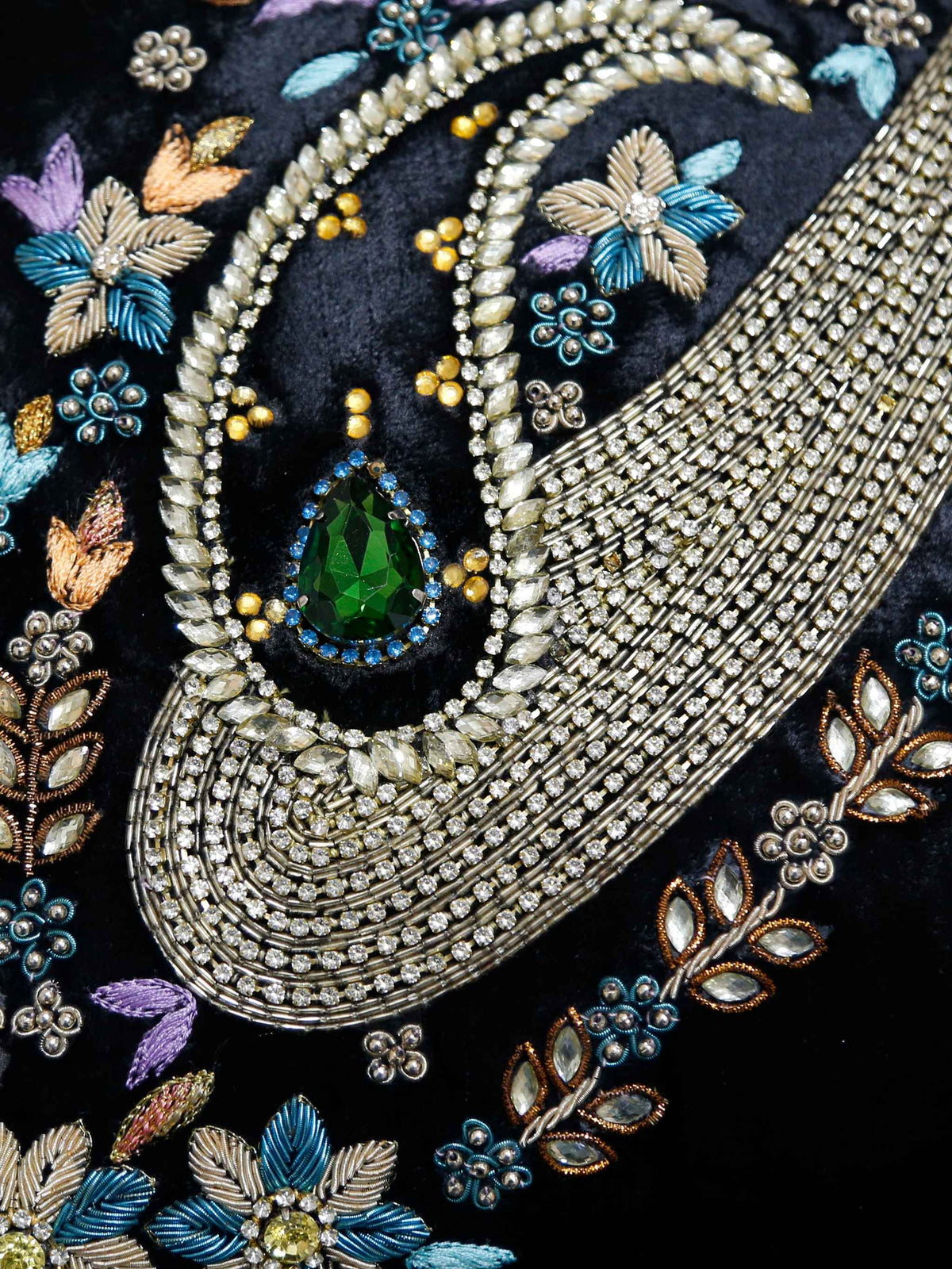 Close-up of the beaded paisley embroidery and green stone