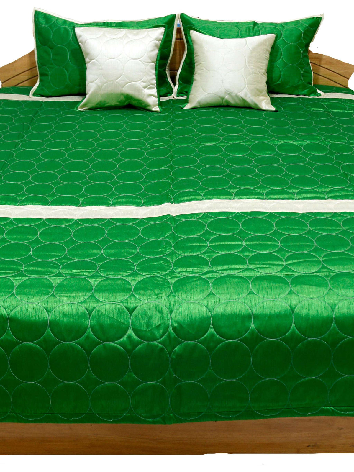 Green circle quilted side laid flat with ivory and green cushion covers