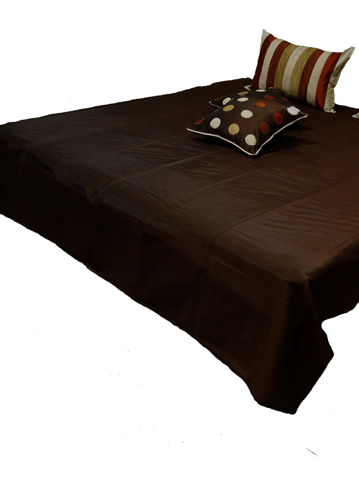 Dark brown bedcover with a single polka-dot cushion at the foot, Circle Design