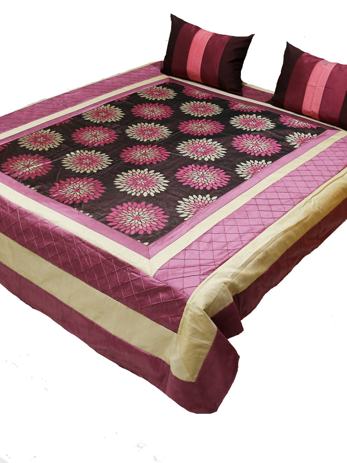 Wine and black lotus print bedcover on a bed with two striped cushion covers, angled