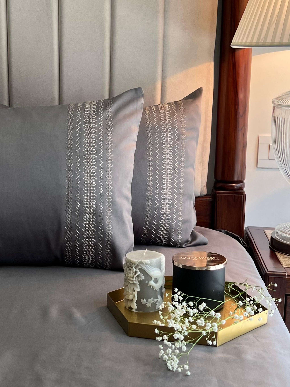 Elephant grey bedding with a cream and gold embroidered pillow band