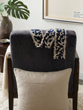 Beige cushion cover with detachable black patterned accent strip