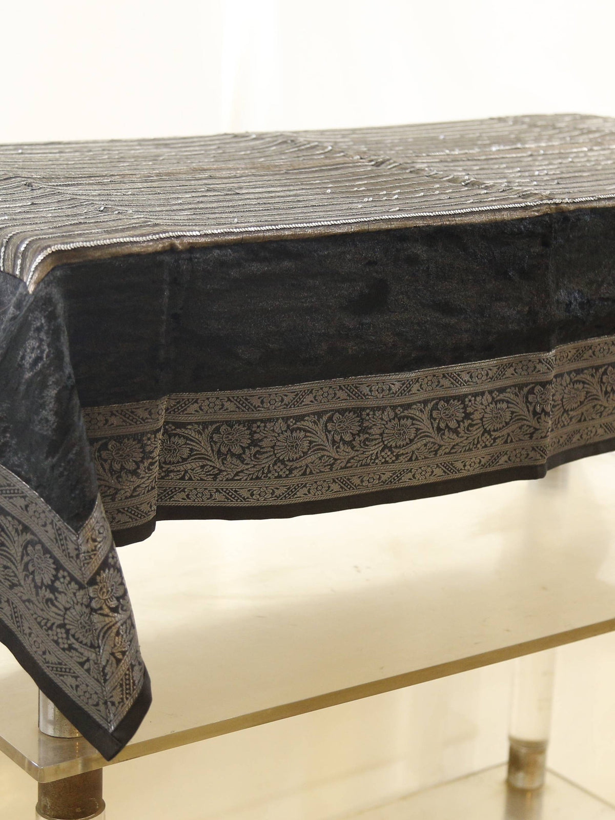 Black velvet table cover with a silver sequinned stripe pattern and a grey-gold floral brocade border