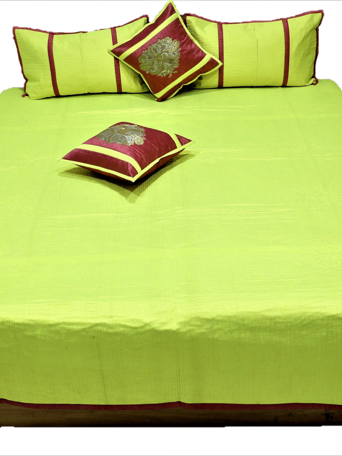 Lime green reverse laid flat with maroon and gold zari cushion covers