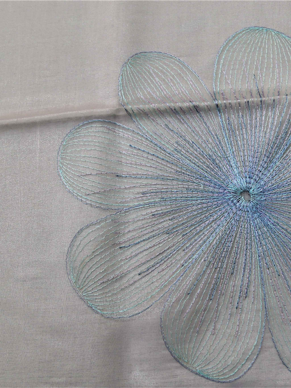 White oval table cover with a blue and purple embroidered flower pattern and a solid teal-blue border