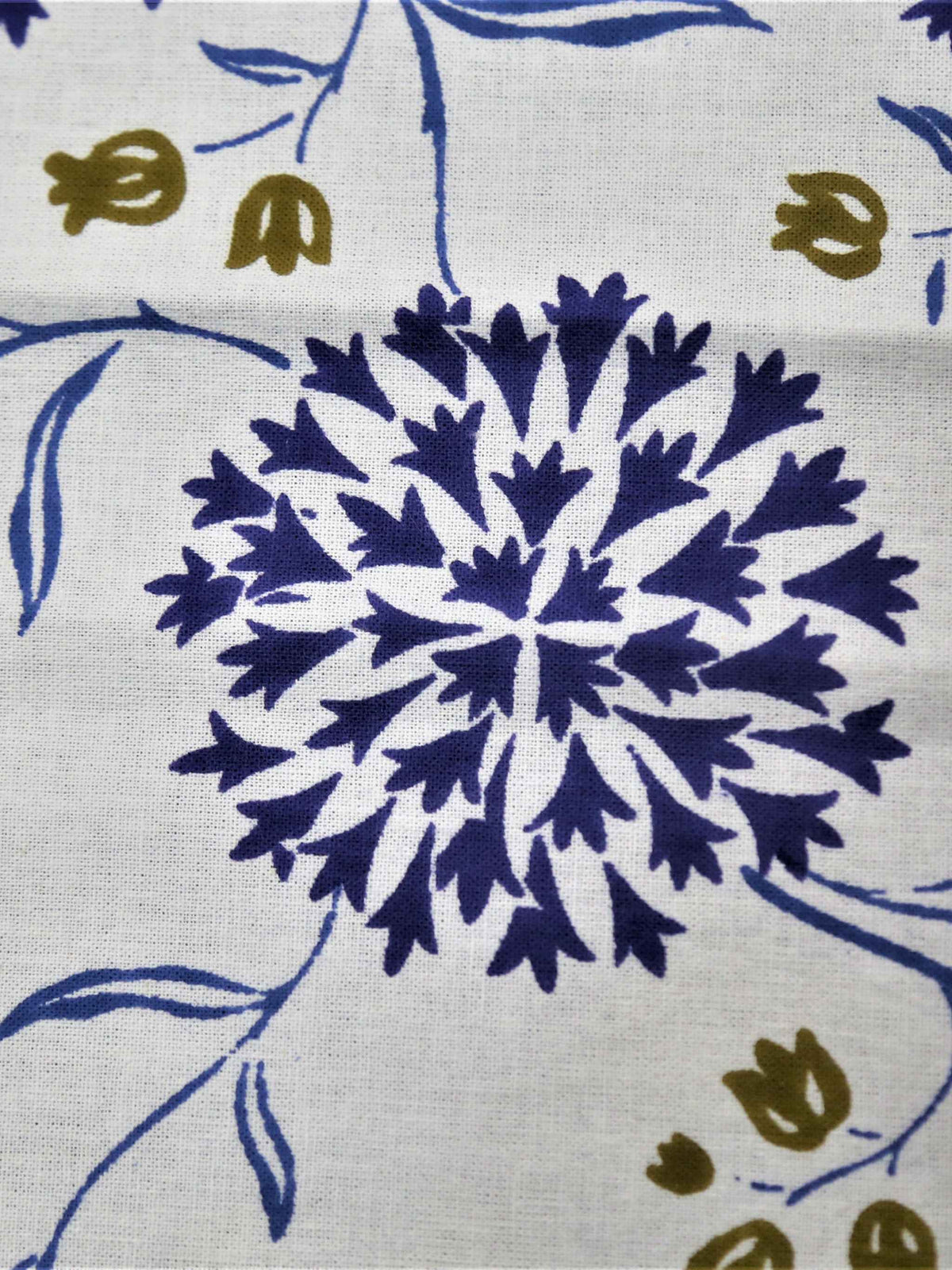 White oval table cover with a navy-blue dahlia and pompom floral print and a navy border with white flowers