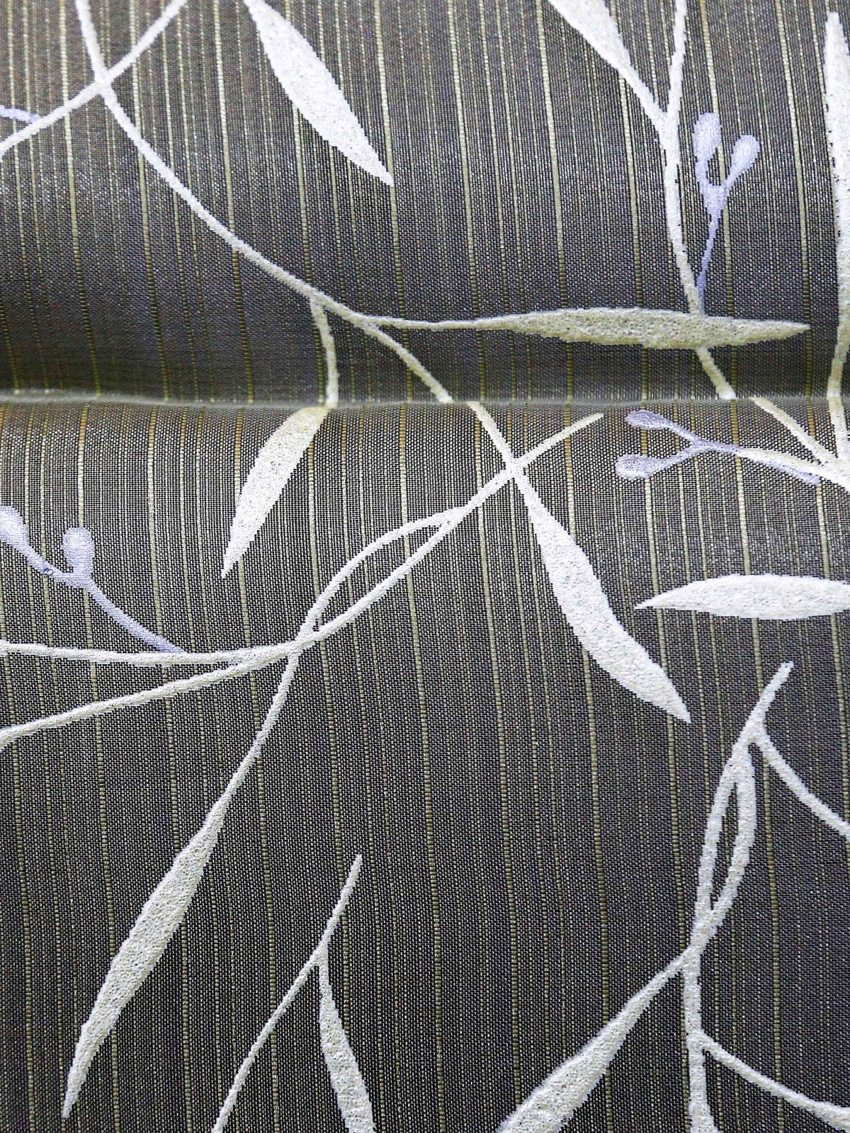 Olive-green table cover with a white and silver embroidered leaf-and-vine pattern and a pale mint-green satin border