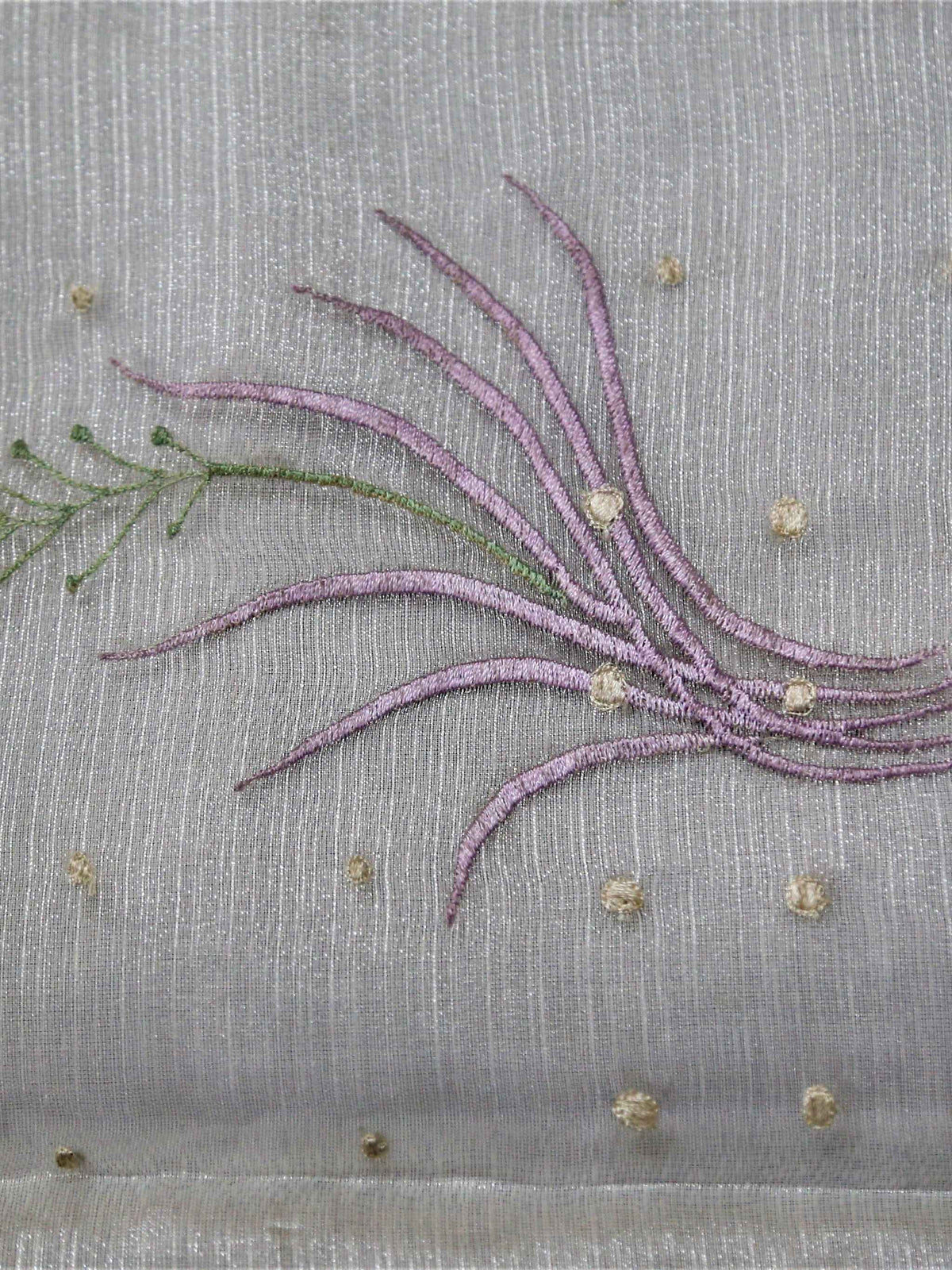 White table cover with lavender embroidered wheat-sprig motifs and scattered gold dots, with a mint-green checkered underskirt trimmed in pink