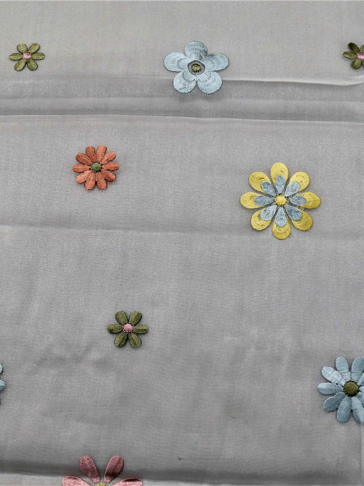 White table cover with a sequinned multicolour daisy dot pattern and a solid sea-green satin border