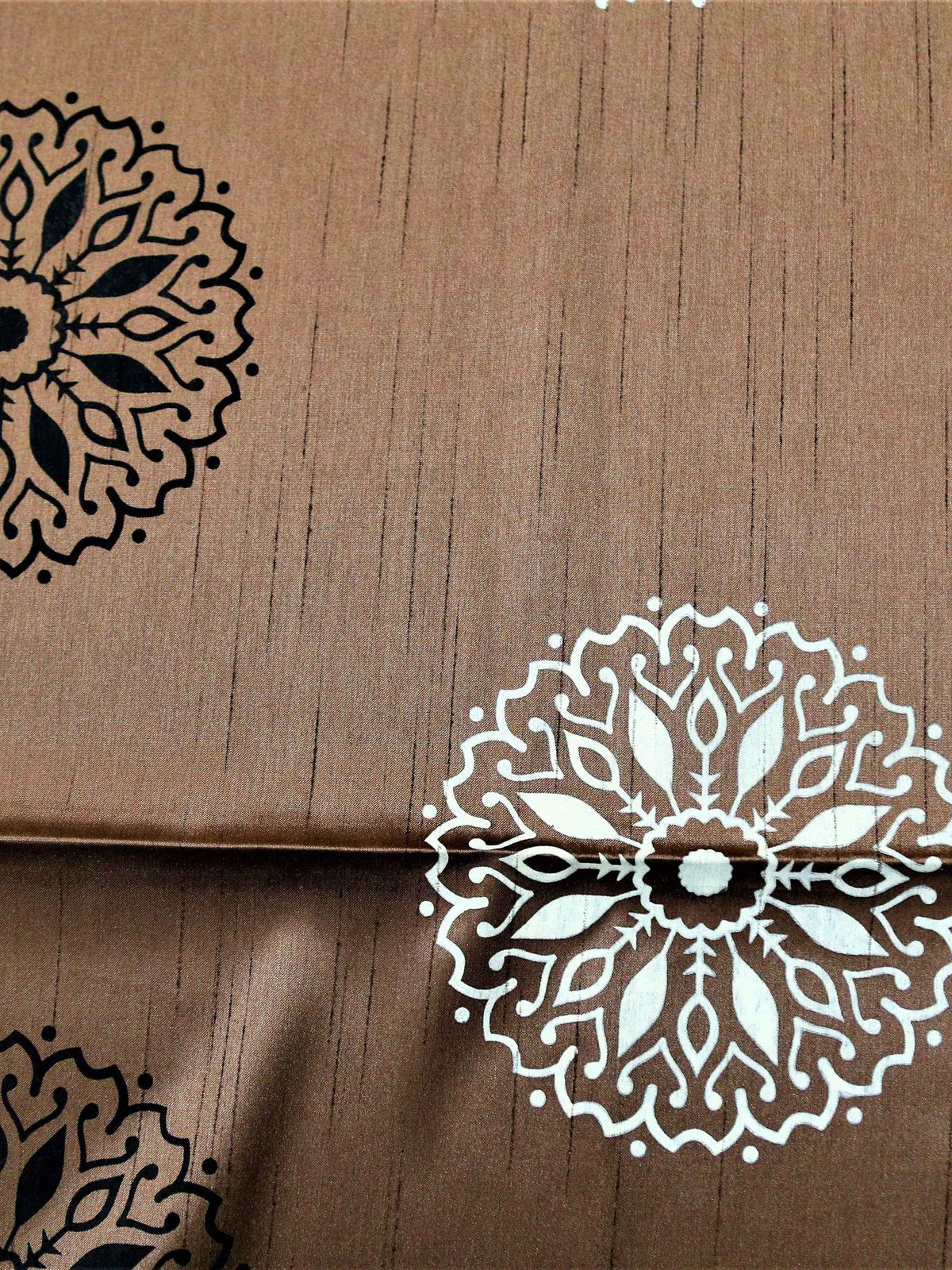 Dusty pink-brown table cover with a black and white block-printed mandala medallion pattern and a black lace-trimmed border