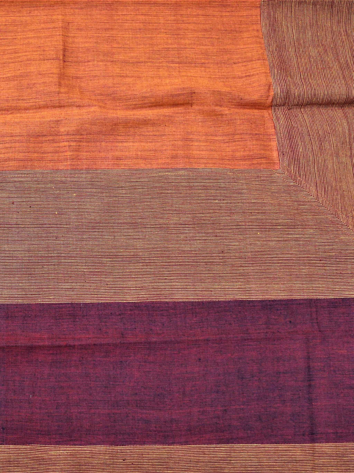 Solid rust-orange table cover with a maroon and rust horizontal striped border
