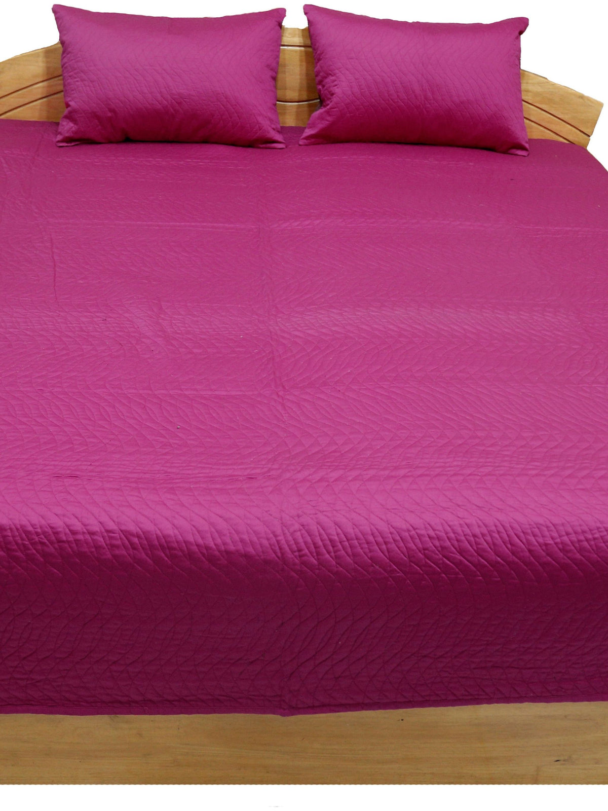 Magenta reverse side of the quilted bedcover with matching magenta pillow covers