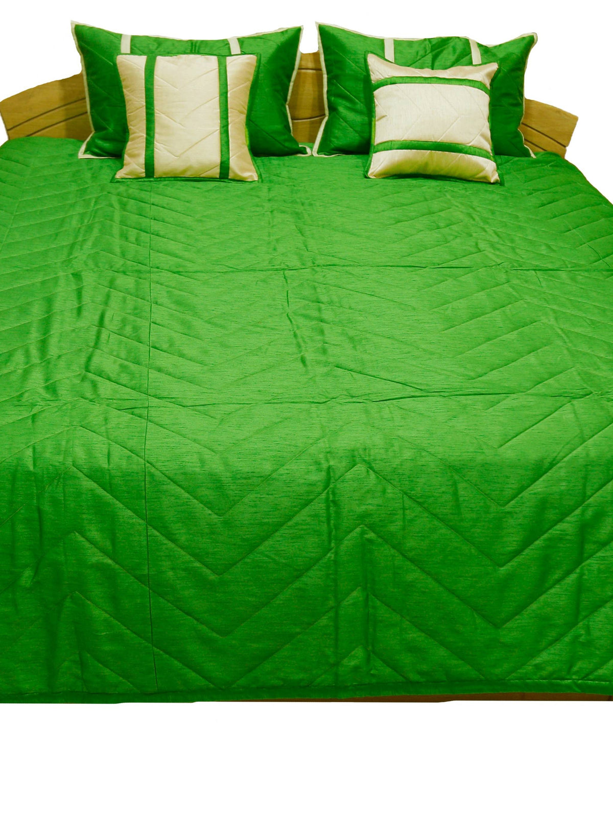 Emerald green quilted bedcover with two cream and green cushion covers