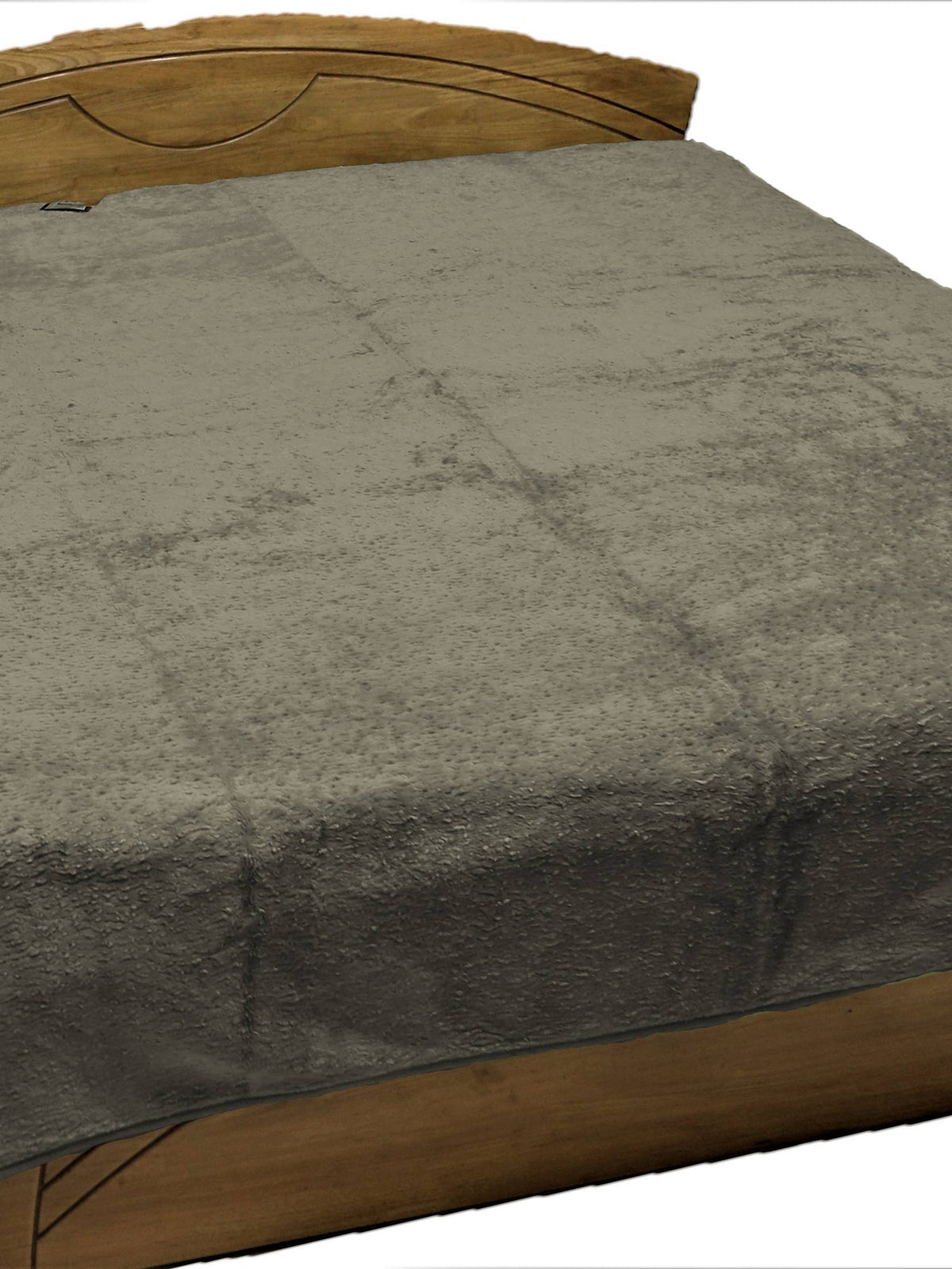 Olive grey fur-finish blanket spread over a double bed, Monaco