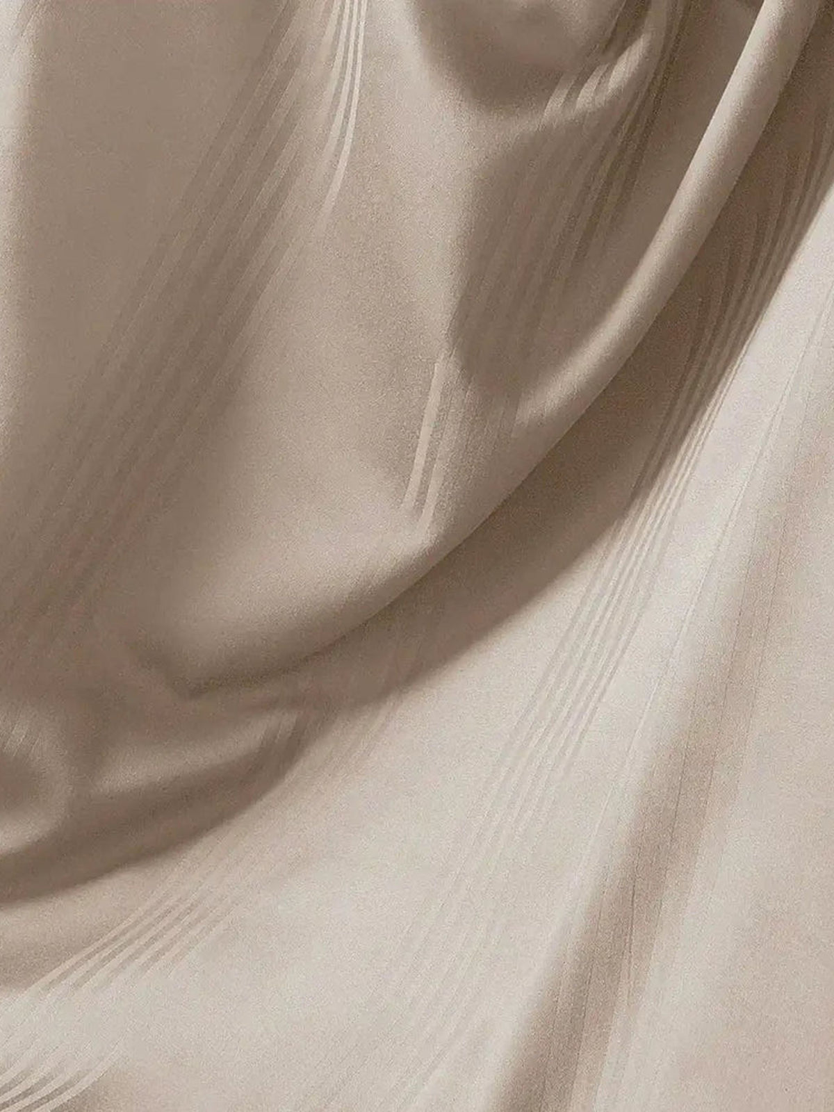 Close-up of taupe satin stripe cotton falling in soft folds