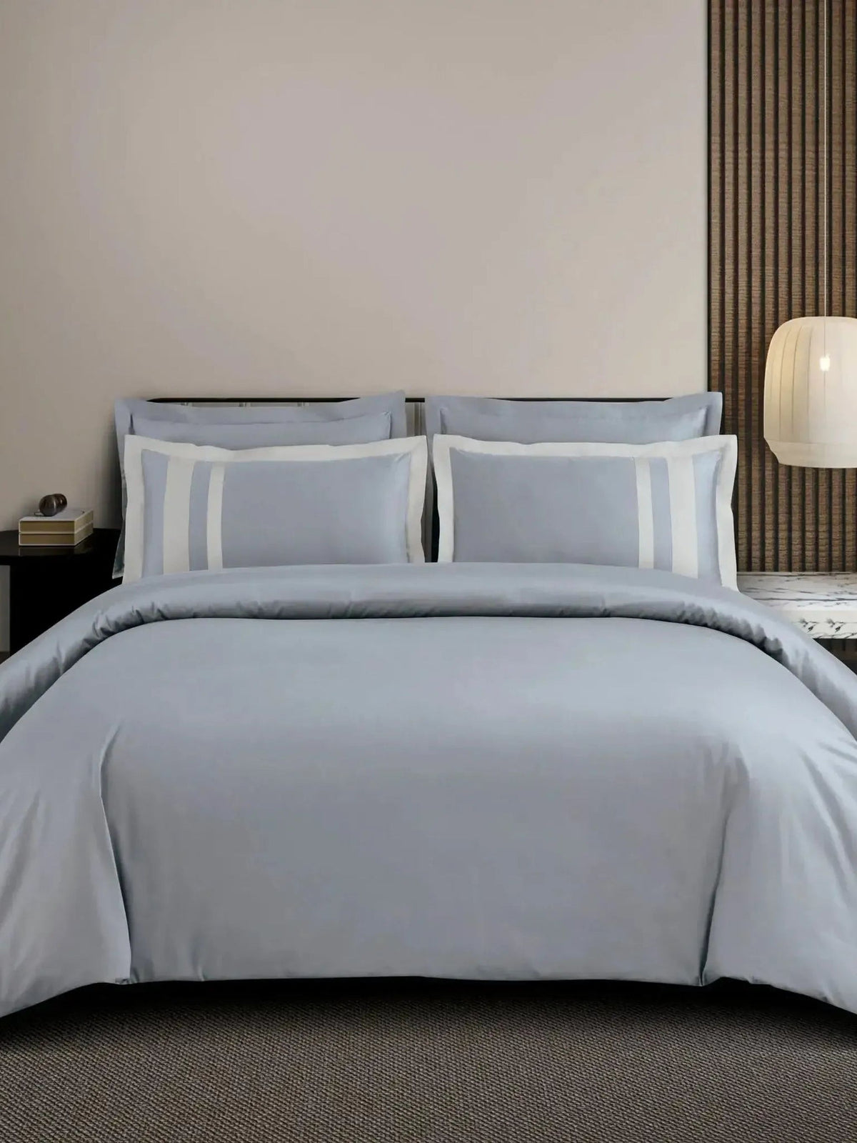 Light grey cotton bedsheet set with a white block-stripe border on the pillow covers, styled on a bed
