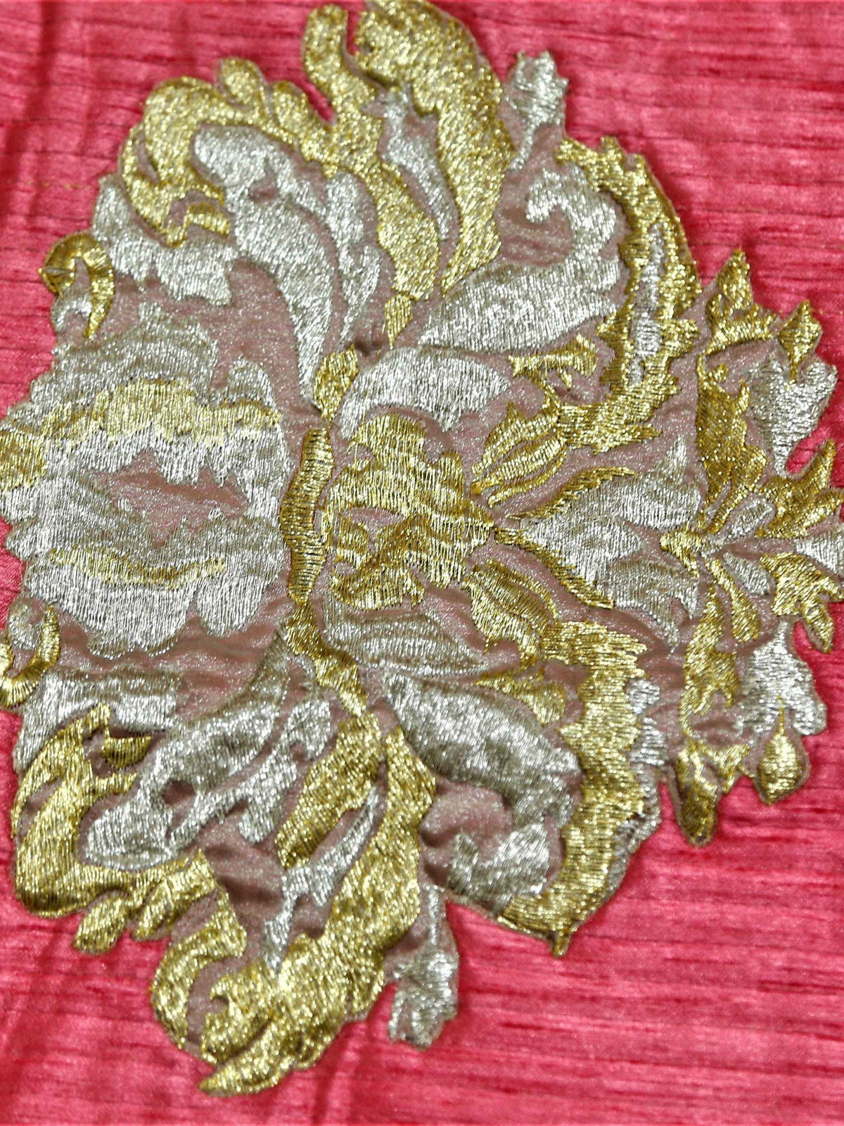 Close-up of gold and silver zari floral motif embroidered on coral rose silk
