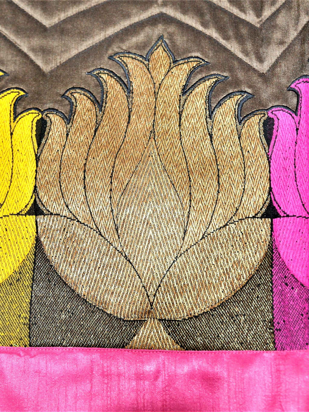 Close-up of gold, pink and yellow lotus applique on brown chevron velvet band