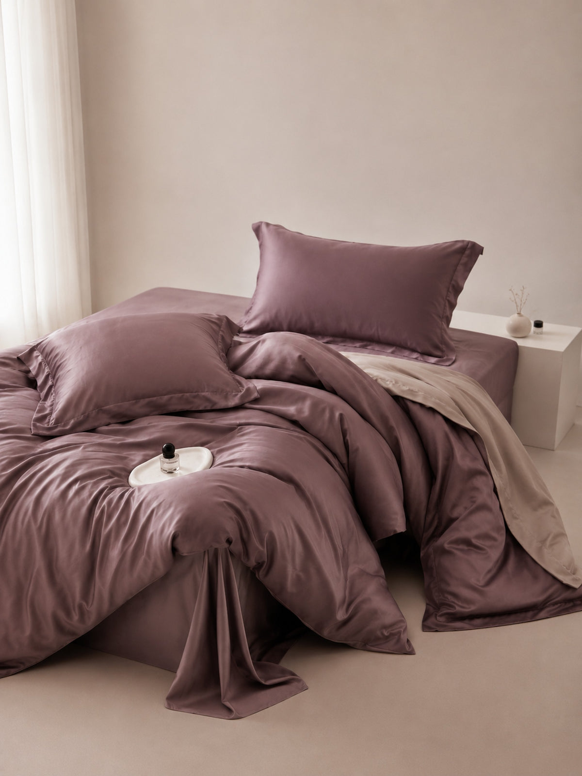 Plum brown Tencel duvet cover and pillows in a soft-lit bedroom