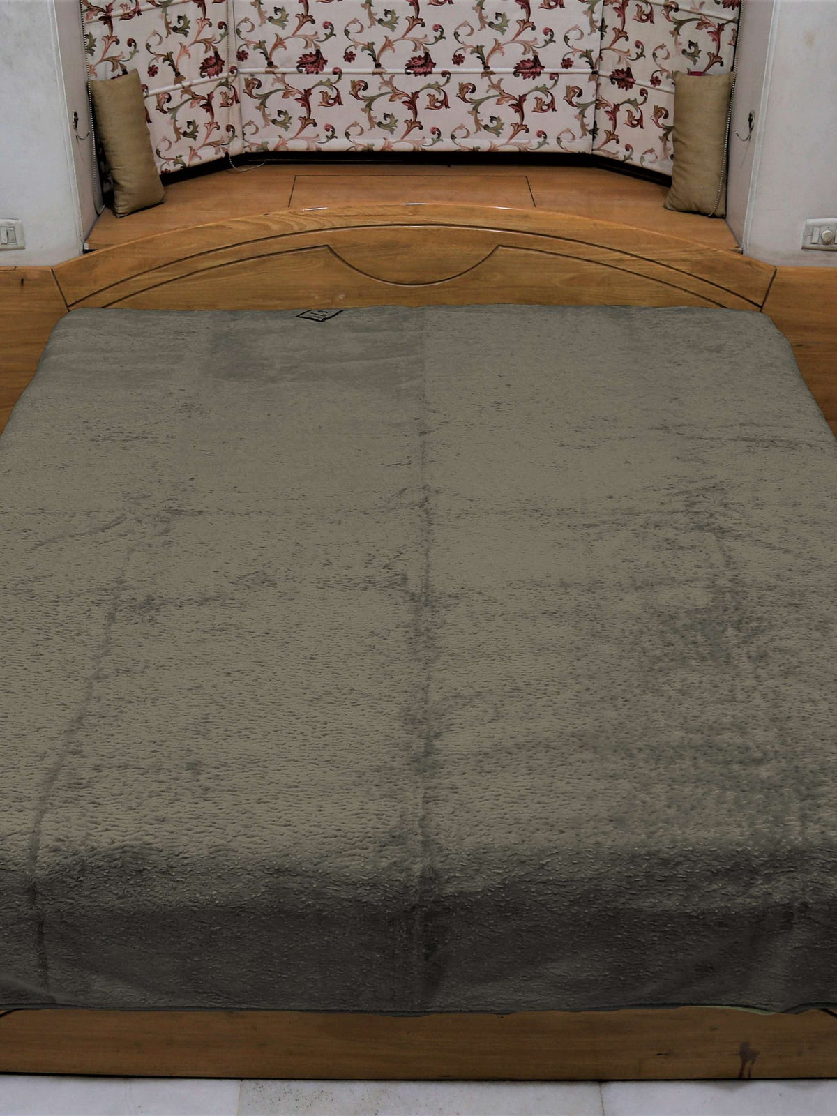 Olive grey Monaco blanket seen square on across a double bed