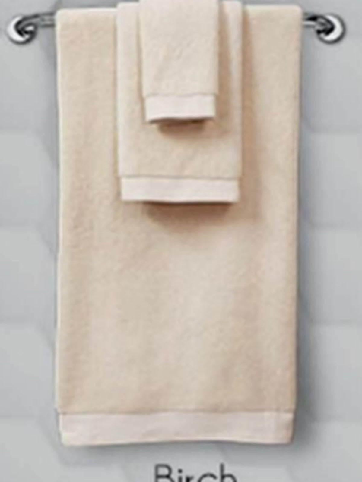 Cream cotton towel set hanging on a rail, hand towel in Birch