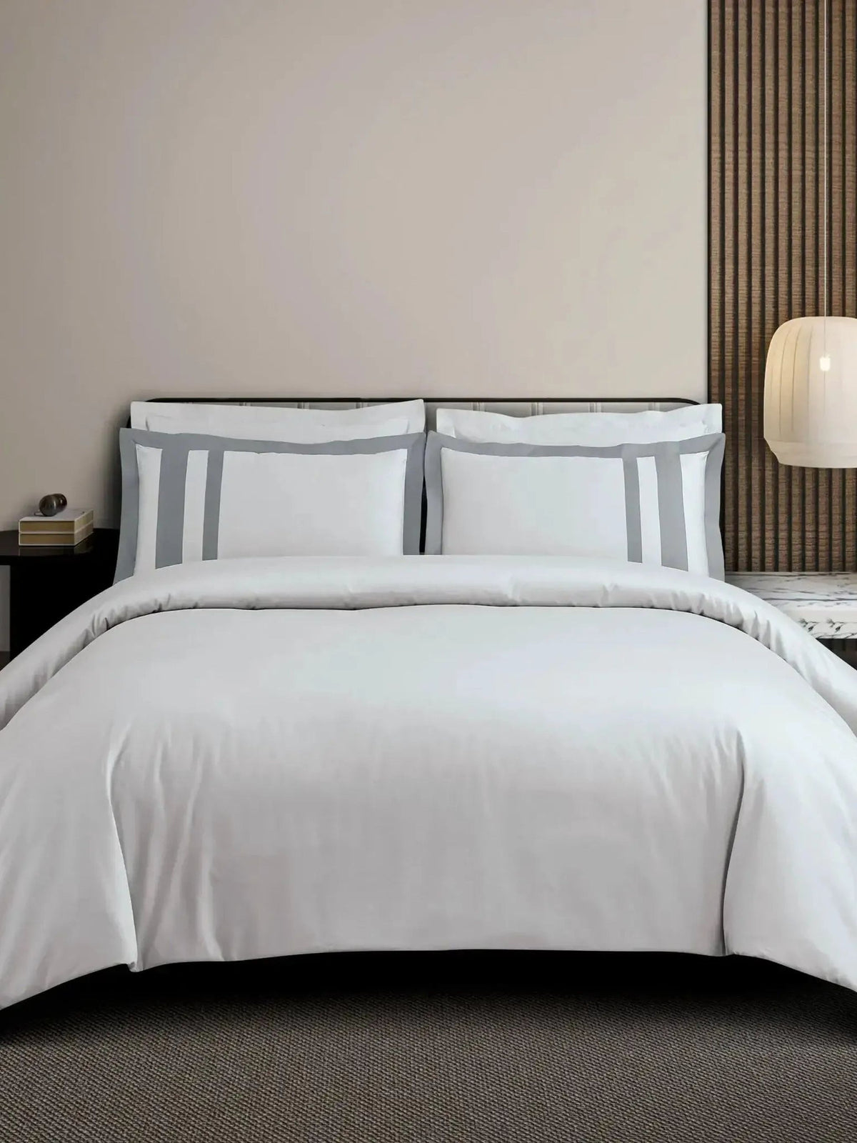 White cotton bedsheet set with a silver-grey block-stripe border on the pillow covers, styled on a bed
