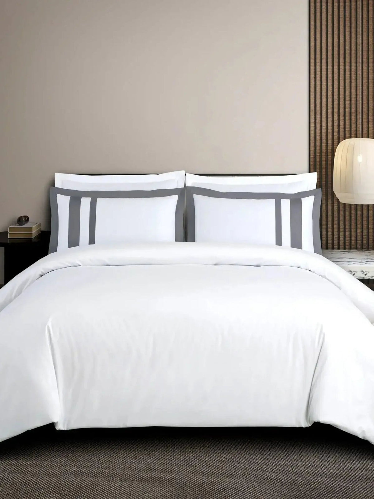 White cotton bedsheet set with a dark grey block-stripe border on the pillow covers, styled on a bed