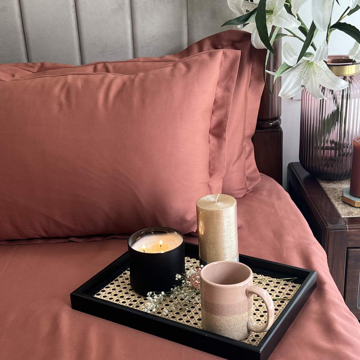 Clay rose sateen pillows with a candle and coffee tray, Terracotta Luxe Collection